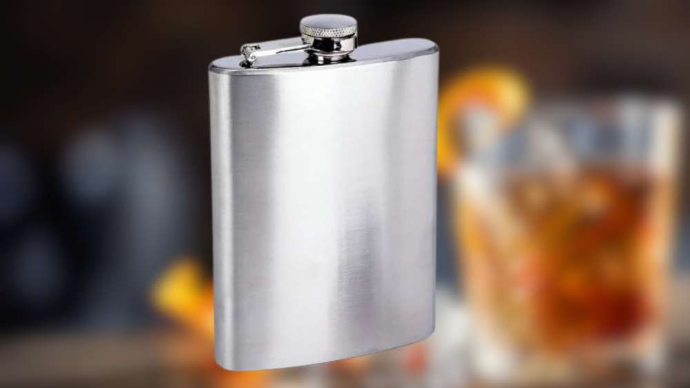 Silver colored eight ounce flask with personalized engraving