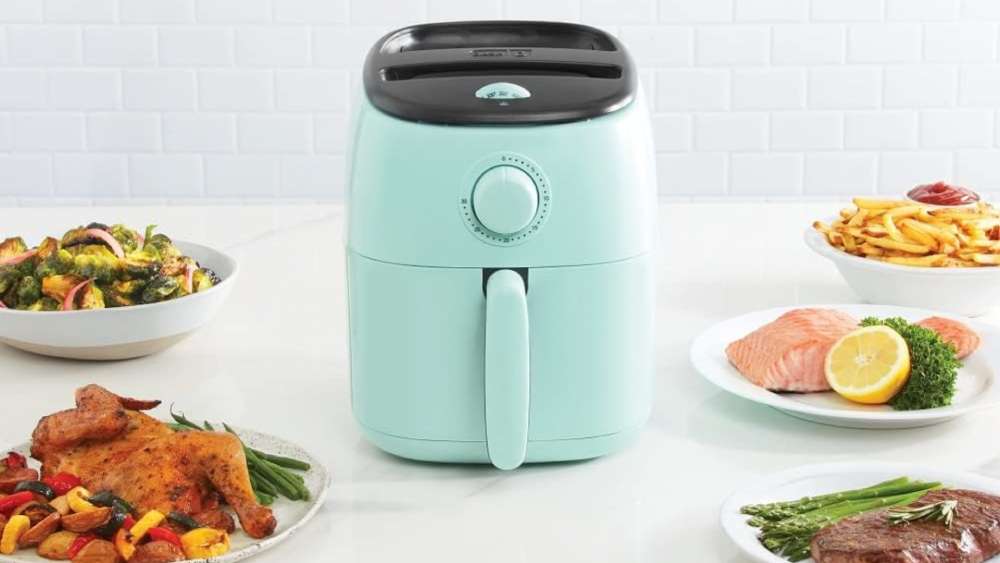 Aqua colored electric air fryer with recipe guide