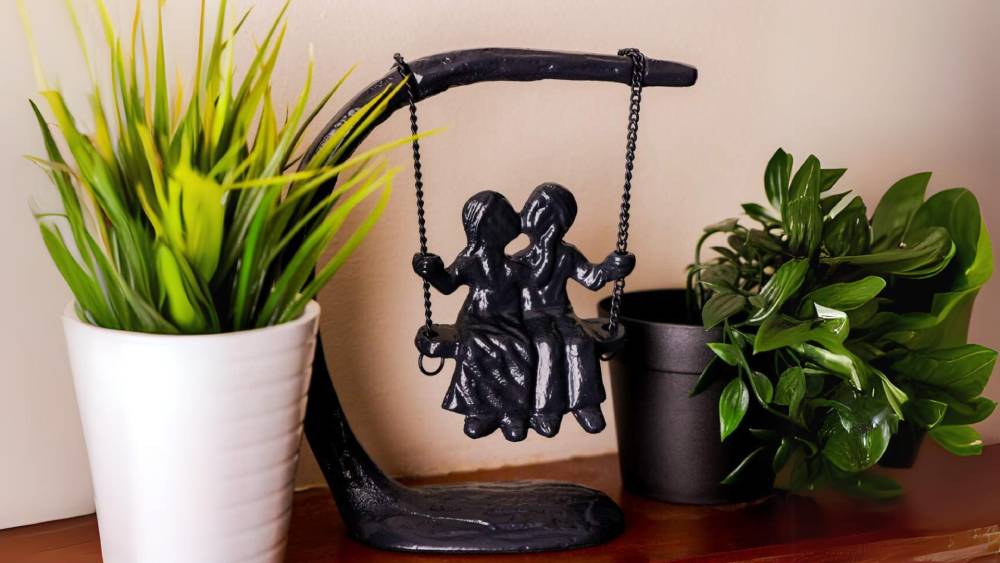 Cast Iron Sculpture Kissing on a swing