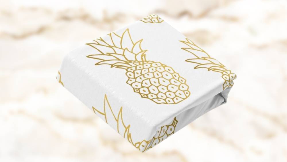 Bed sheets with a tropical pineapple design in gold