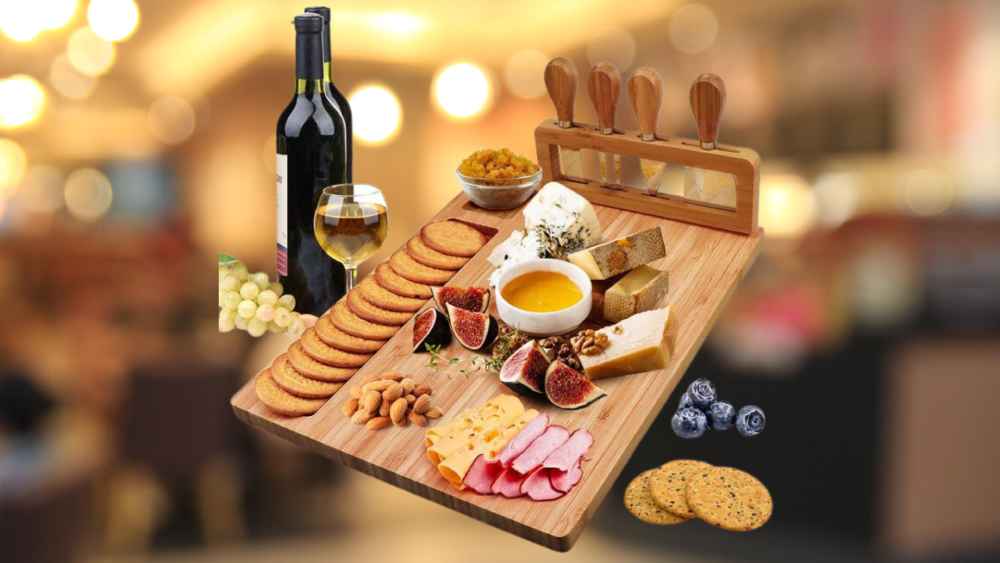 charcuterie board with several cheese utensils and bowls