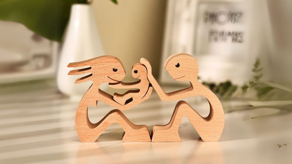 Wooden sculpture couple holding a baby