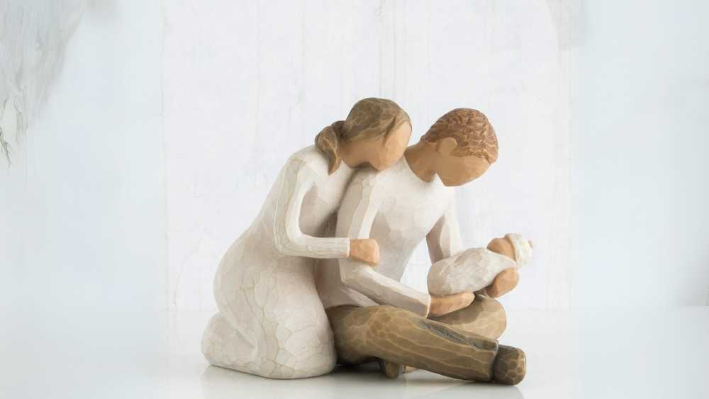 Hand painted couple holding baby