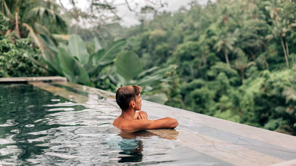 Wellness travel relaxing at infinity pool